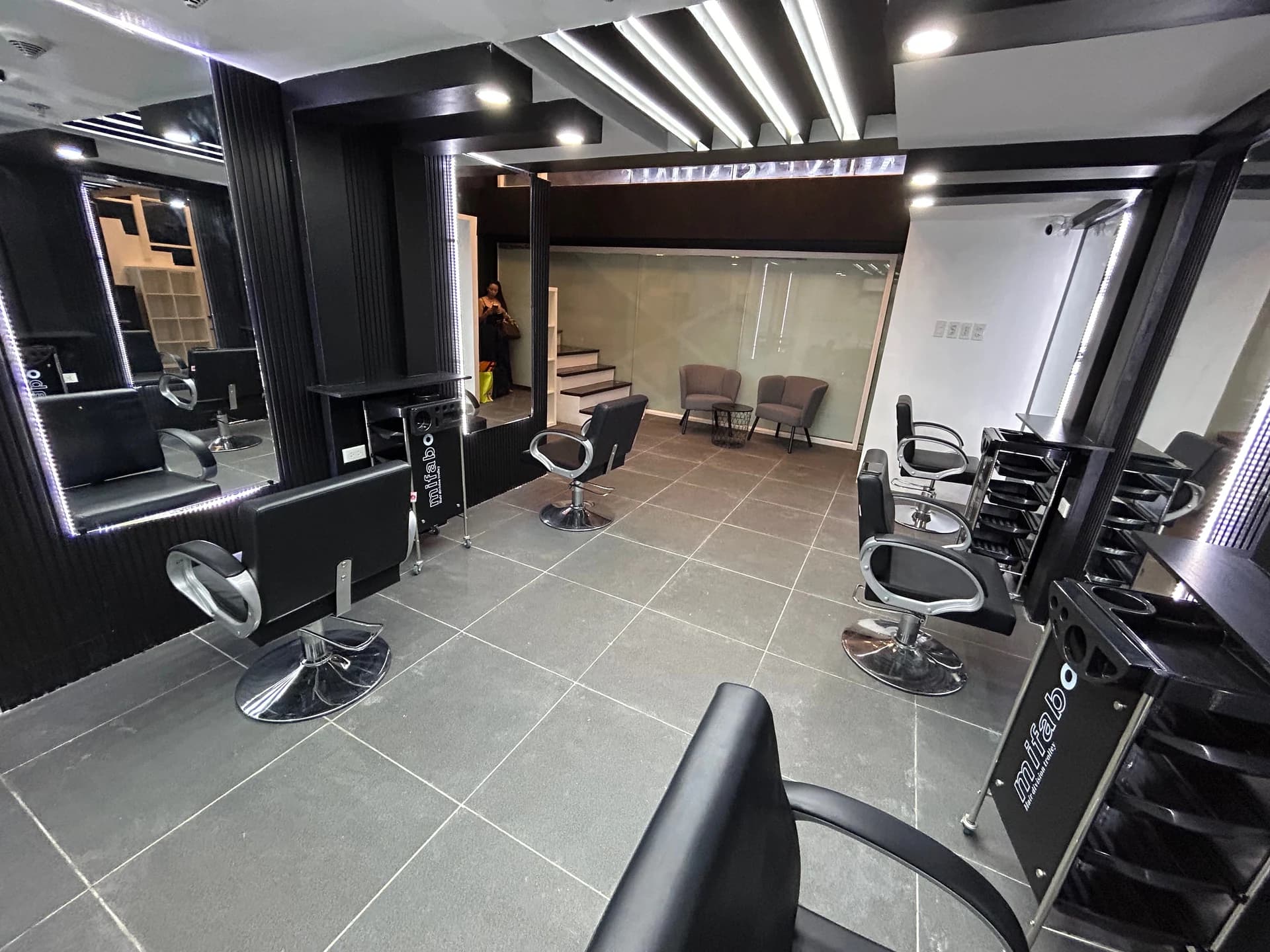 Interior of Beauty Essentials salon — premium styling chairs and lit mirrors, Taguig